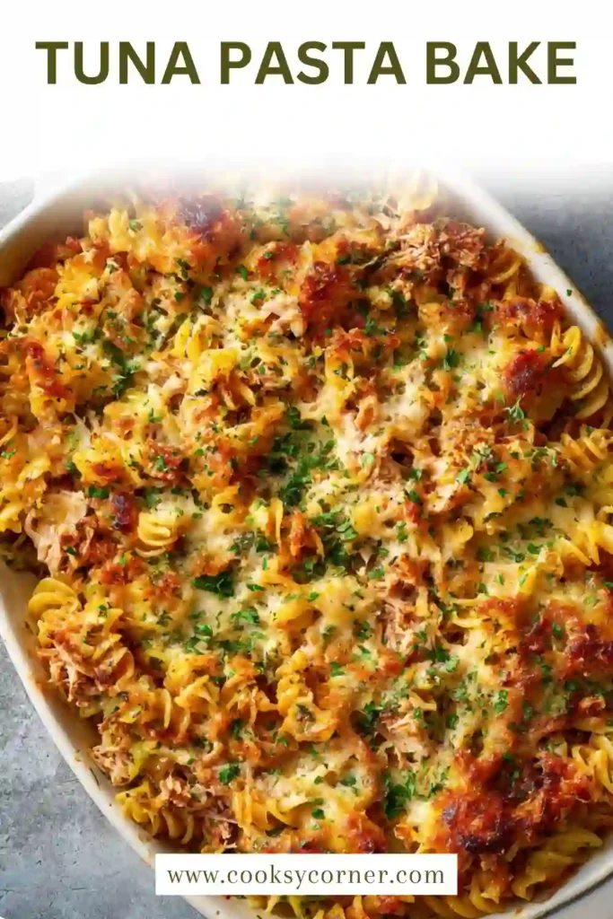 Close-up of baked tuna pasta with broccoli and tomatoes topped with melted cheese.