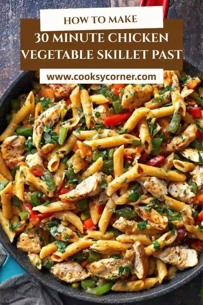 A skillet filled with chicken vegetable pasta featuring colorful bell peppers and penne coated in a light sauce. The dish looks fresh, vibrant, and ready to serve.