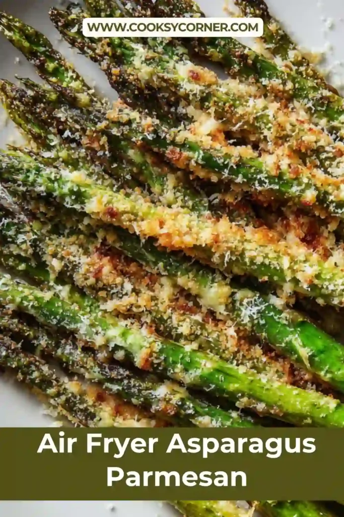 Air fryer asparagus parmesan with crispy cheese topping on a serving plate. Bright green spears with golden edges.