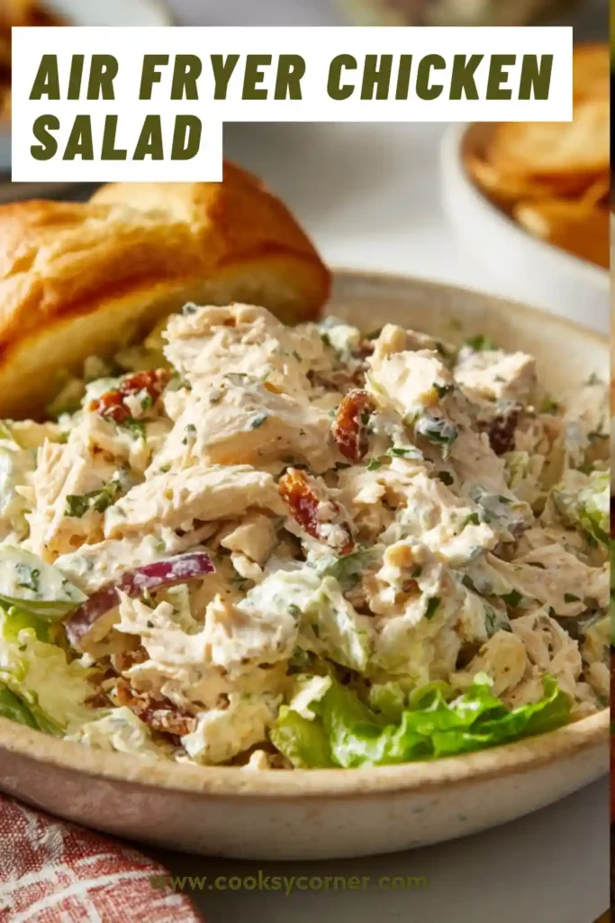 Homemade air fryer chicken salad displayed with fresh ingredients, showing its creamy consistency and chunky texture.