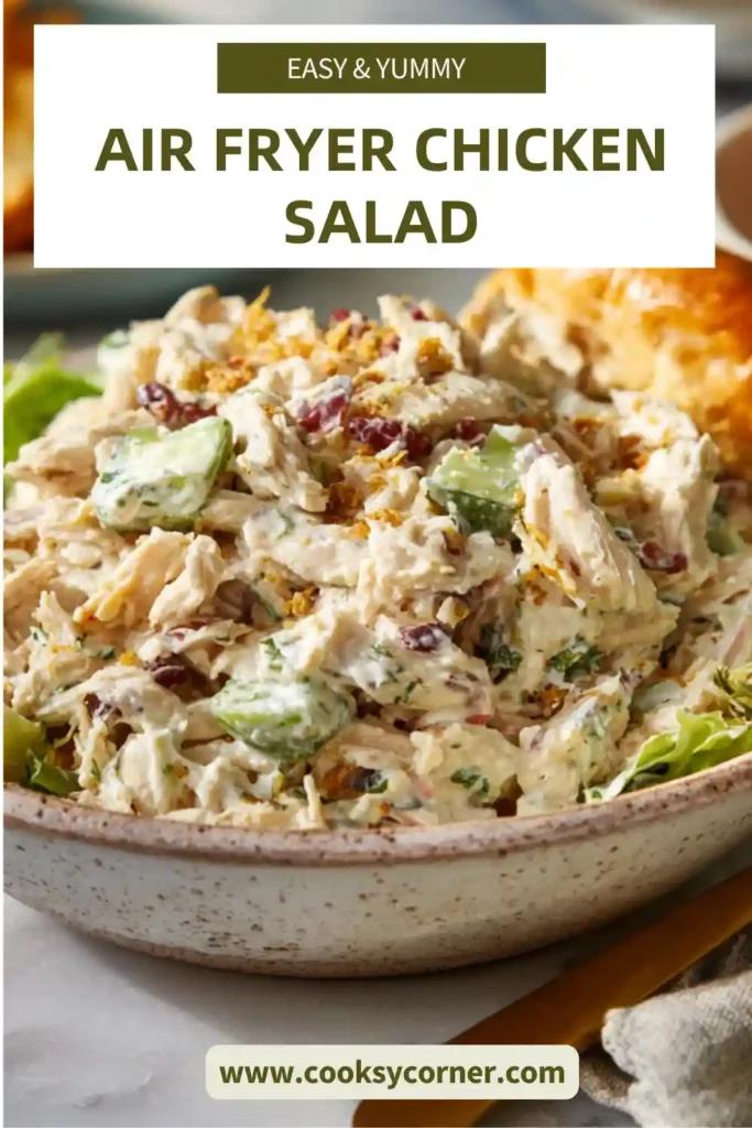A bowl of air fryer chicken salad with creamy dressing, celery, and red onion, served fresh and chilled. The texture looks rich and perfectly blended.