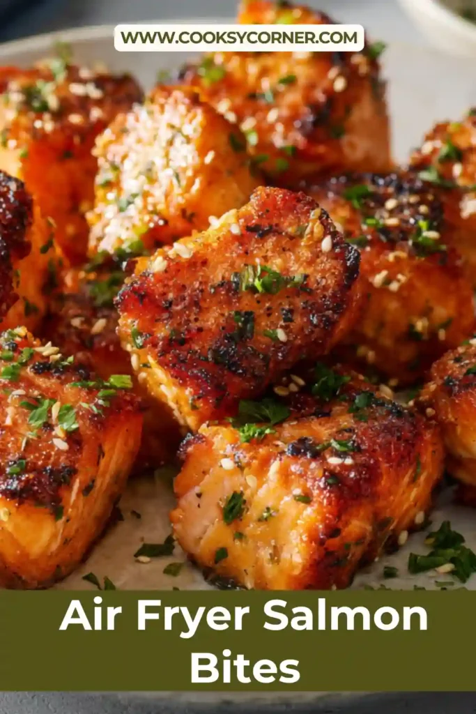Air fryer salmon bites with sesame seeds and green onions on a plate. Golden and juicy texture.