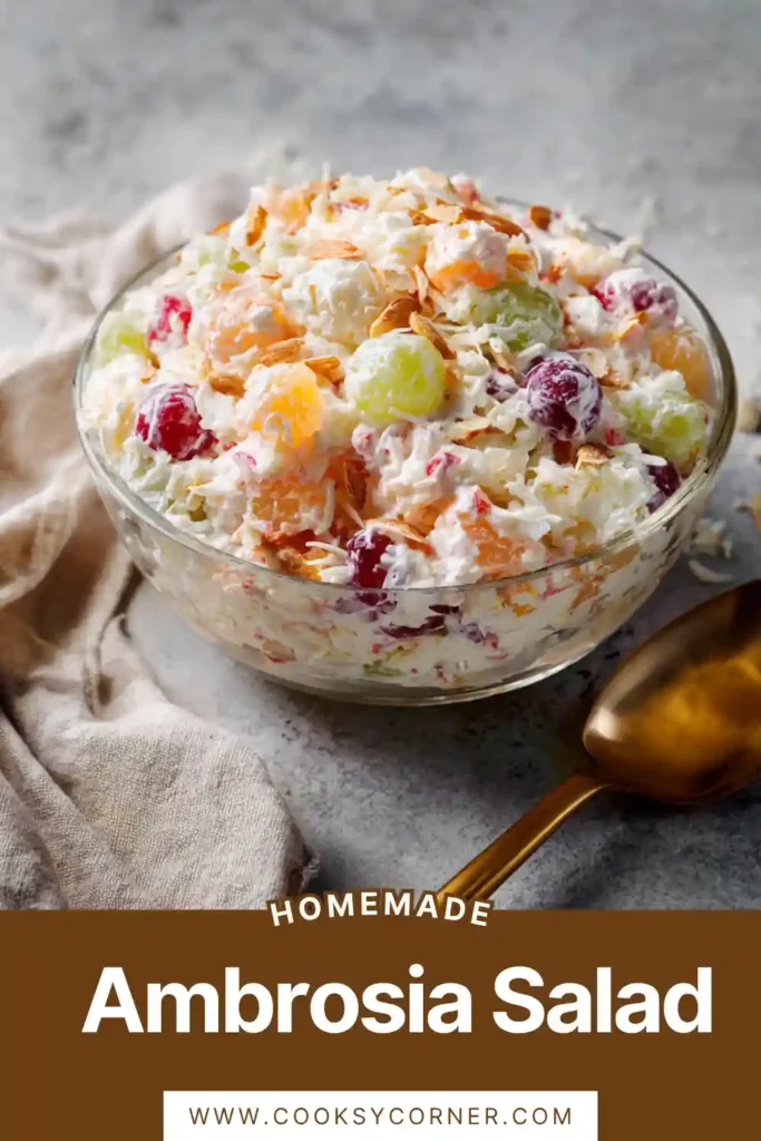 Creamy ambrosia salad with marshmallows, cherries, and pineapple in a serving bowl. The texture looks fluffy and rich.