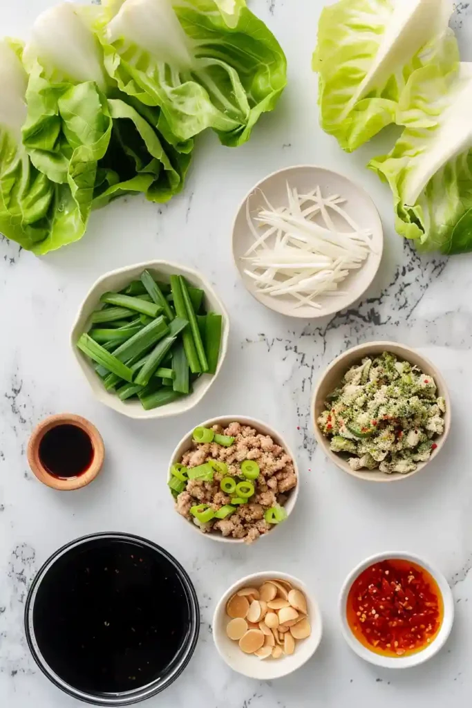 Homemade Asian turkey lettuce wraps arranged on a plate with fresh ingredients.