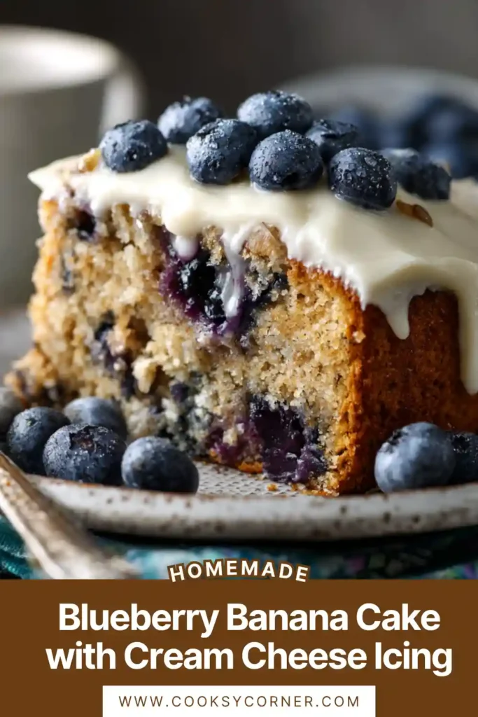 Slice of blueberry banana cake showing fluffy crumb with blueberries and smooth cream cheese frosting.