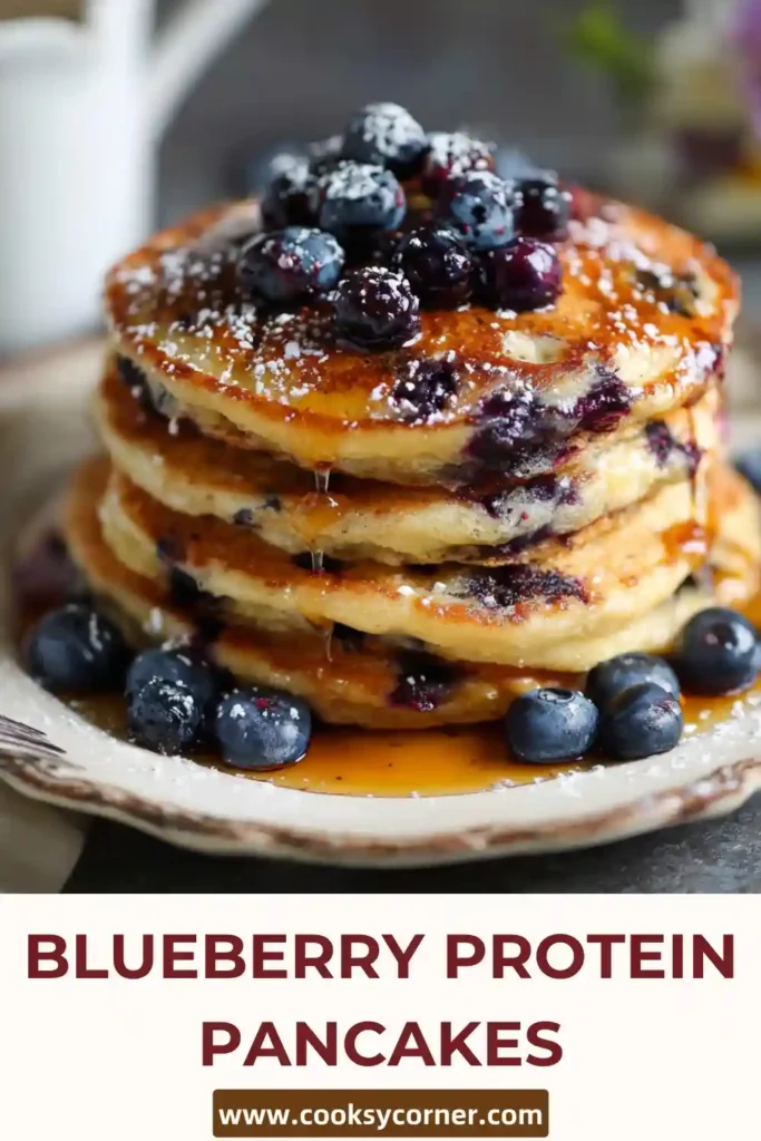 Healthy blueberry protein pancakes served with maple syrup and yogurt.