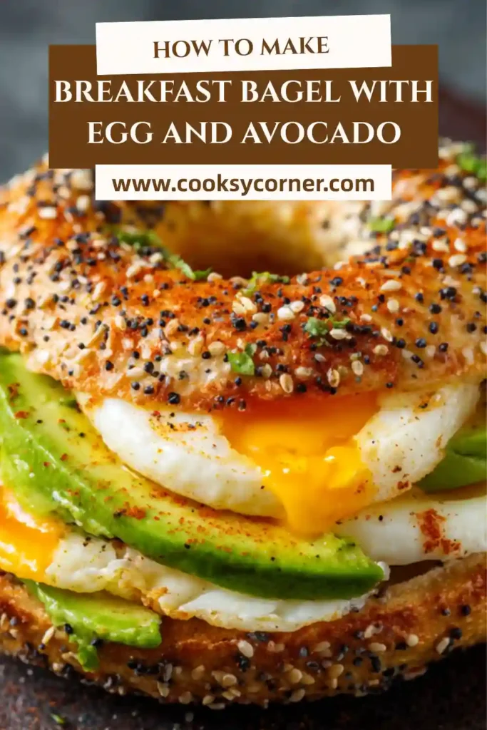 Freshly made egg and avocado breakfast bagel with melted cheese and spicy sauce, served warm.