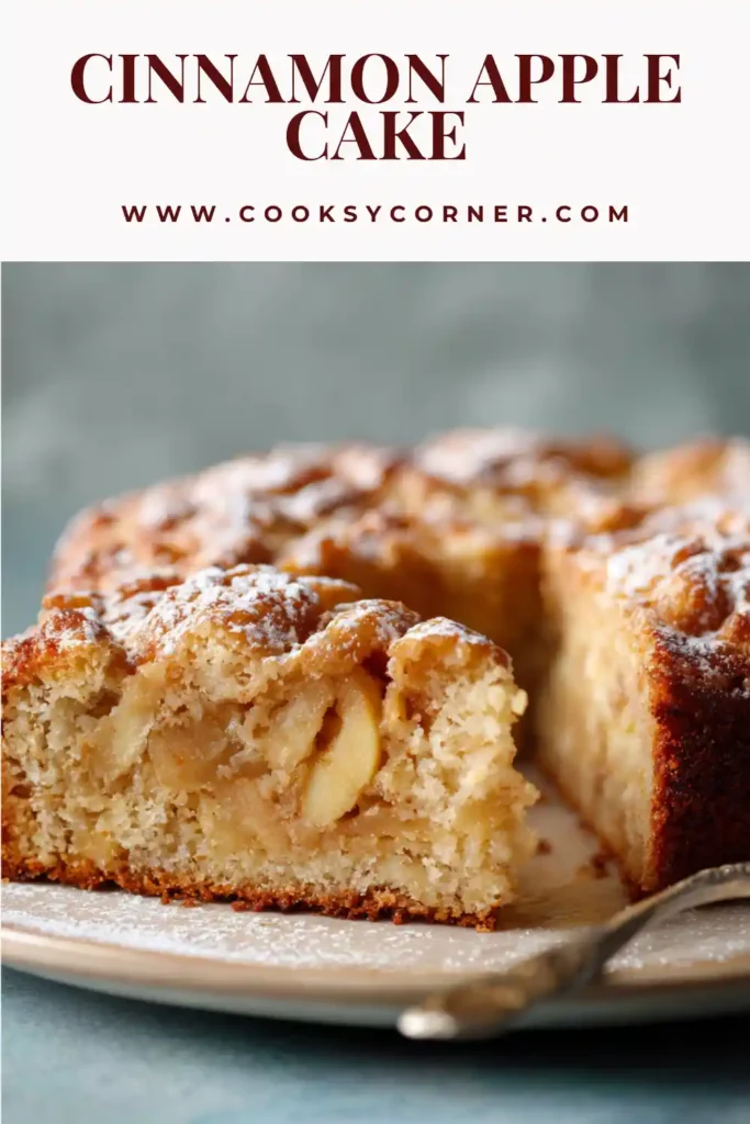A round cinnamon apple cake with golden top and drizzled sugar glaze.