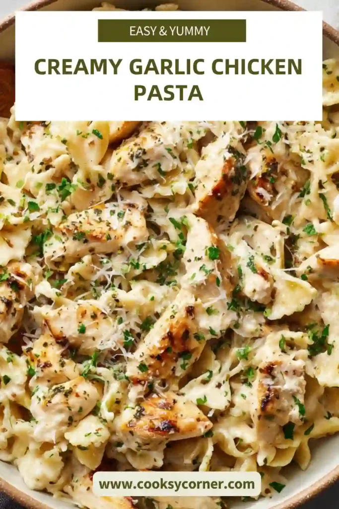Close-up of creamy chicken pasta showing garlic sauce coating penne and juicy chicken pieces.
