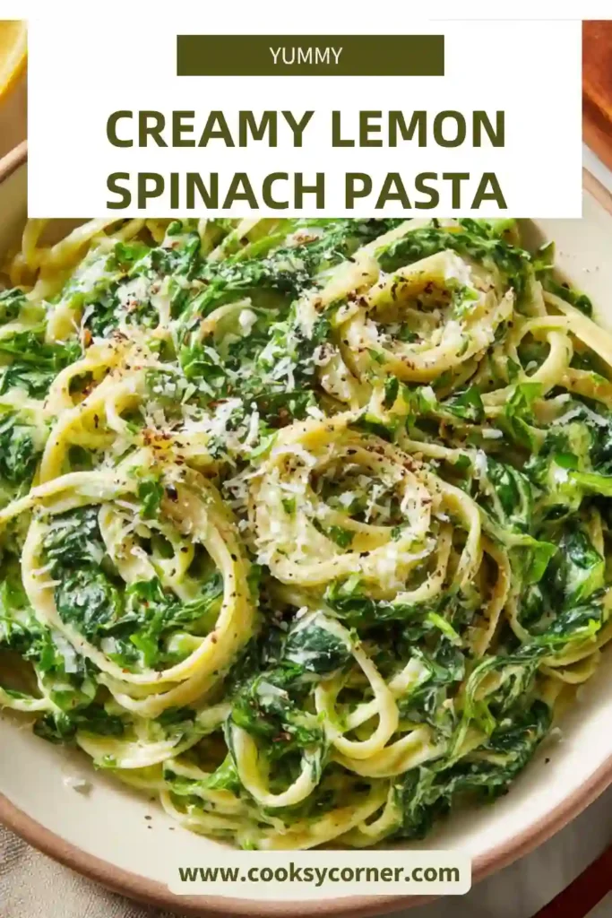 Healthy creamy lemon spinach pasta served in a bowl with fresh herbs and toasted walnuts on top.