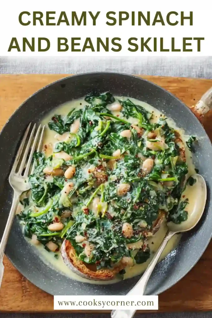 Freshly cooked creamy spinach and beans skillet garnished with lemon zest and served warm.