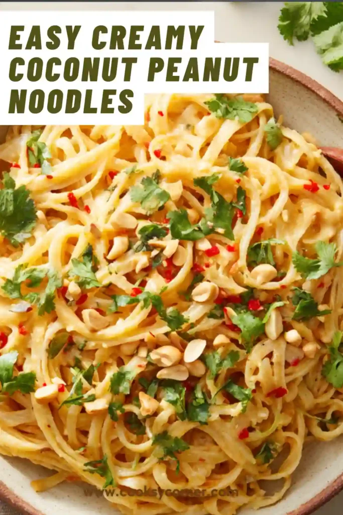 A bowl of creamy coconut peanut noodles topped with green onions and crushed peanuts, coated in a rich peanut curry sauce.