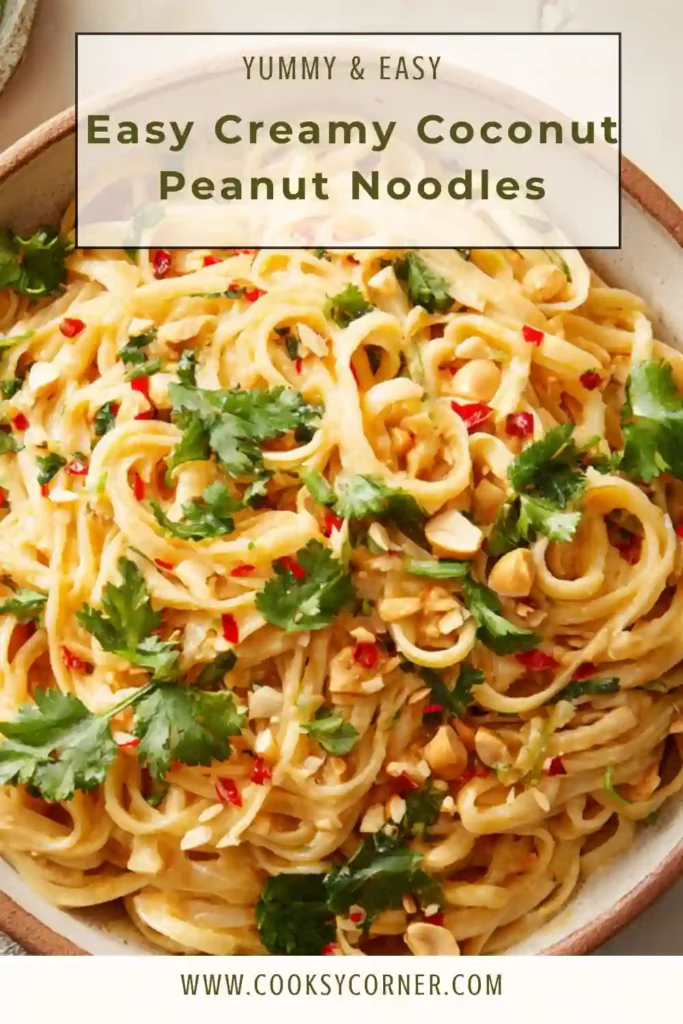 Freshly cooked peanut curry noodles with coconut milk, garnished with lime wedges and chili oil.