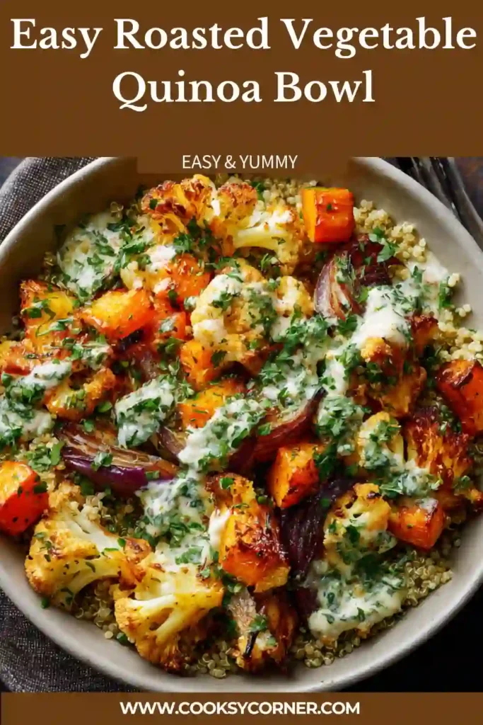A roasted vegetable quinoa bowl filled with colorful vegetables, fluffy quinoa, and tahini sauce in a ceramic bowl.