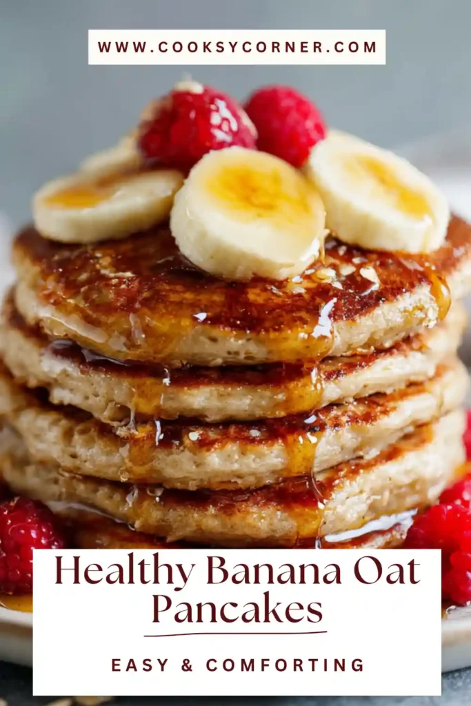 Healthy banana oat pancakes stacked with fresh fruit and maple syrup on top, made from a flourless blender recipe.