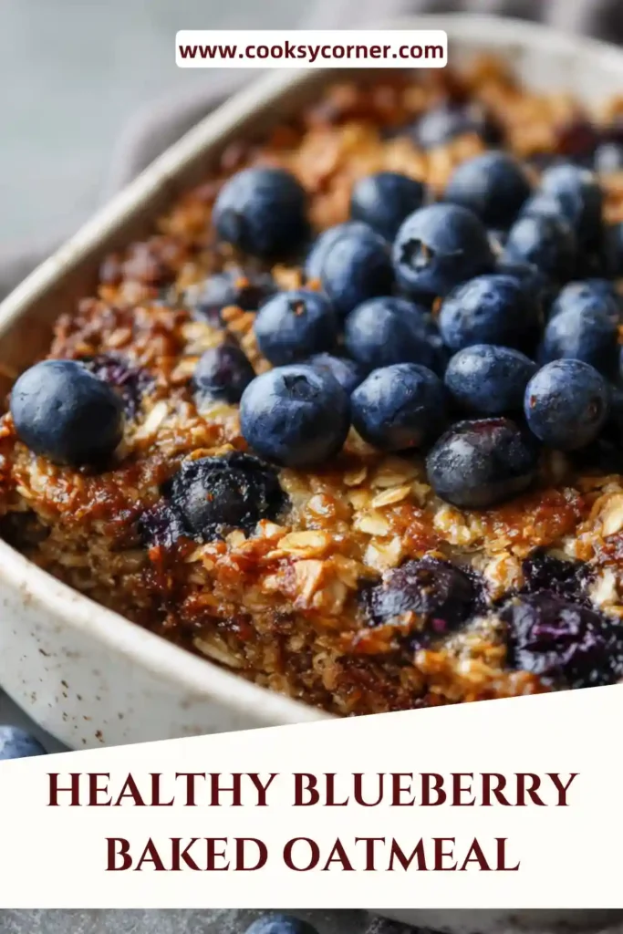 A baked dish of healthy blueberry baked oatmeal topped with fresh blueberries and almonds, showing a soft and golden texture.