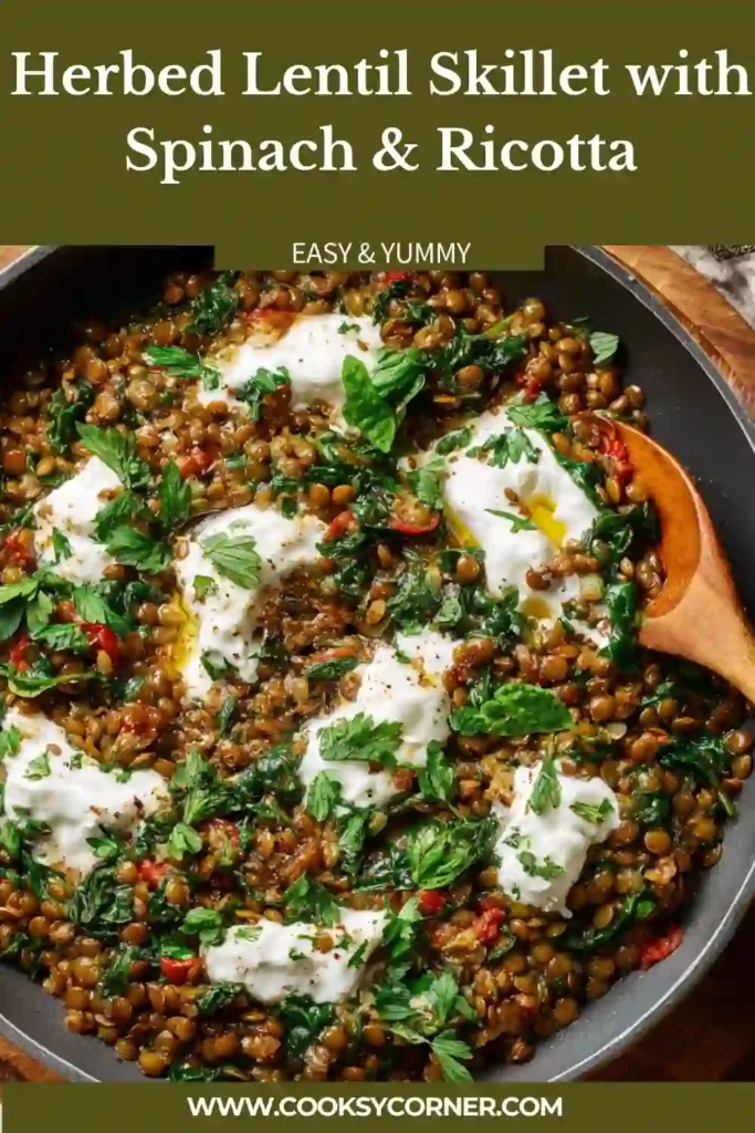 Close-up of lentils with spinach and tomatoes topped with soft ricotta cheese.