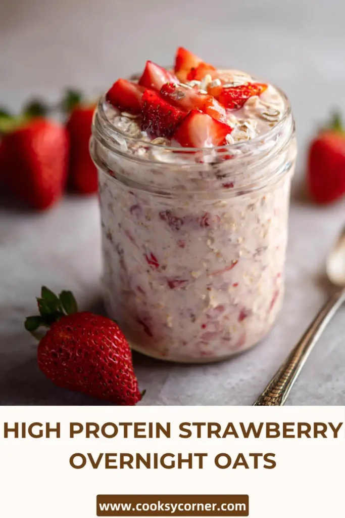 High protein strawberry overnight oats in a jar topped with fresh strawberries and chia seeds. Creamy texture visible.