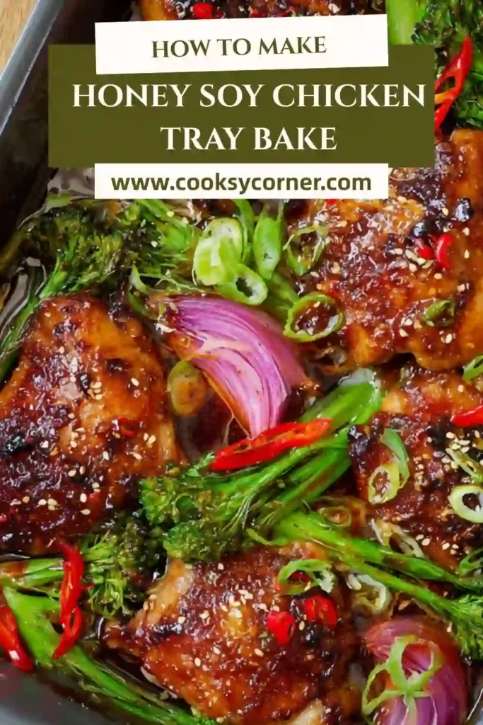Oven baked honey soy chicken tray bake served with sesame seeds and fresh herbs. The dish looks rich and savory.