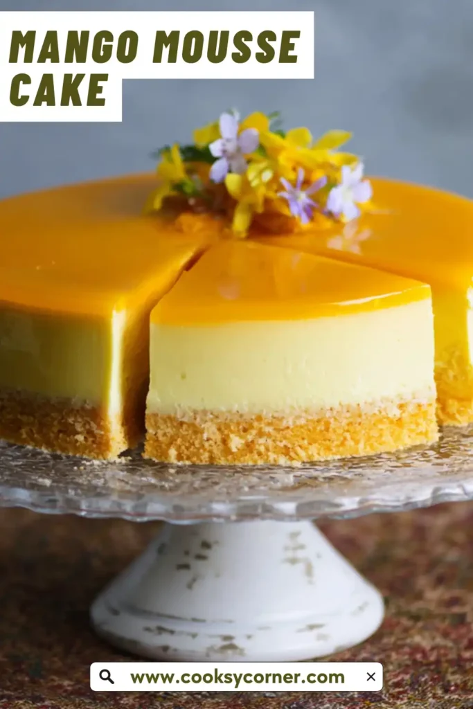 A layered Mango Mousse Cake with soft sponge base, creamy mousse center, and glossy mango topping. The cake has a smooth, vibrant yellow finish.