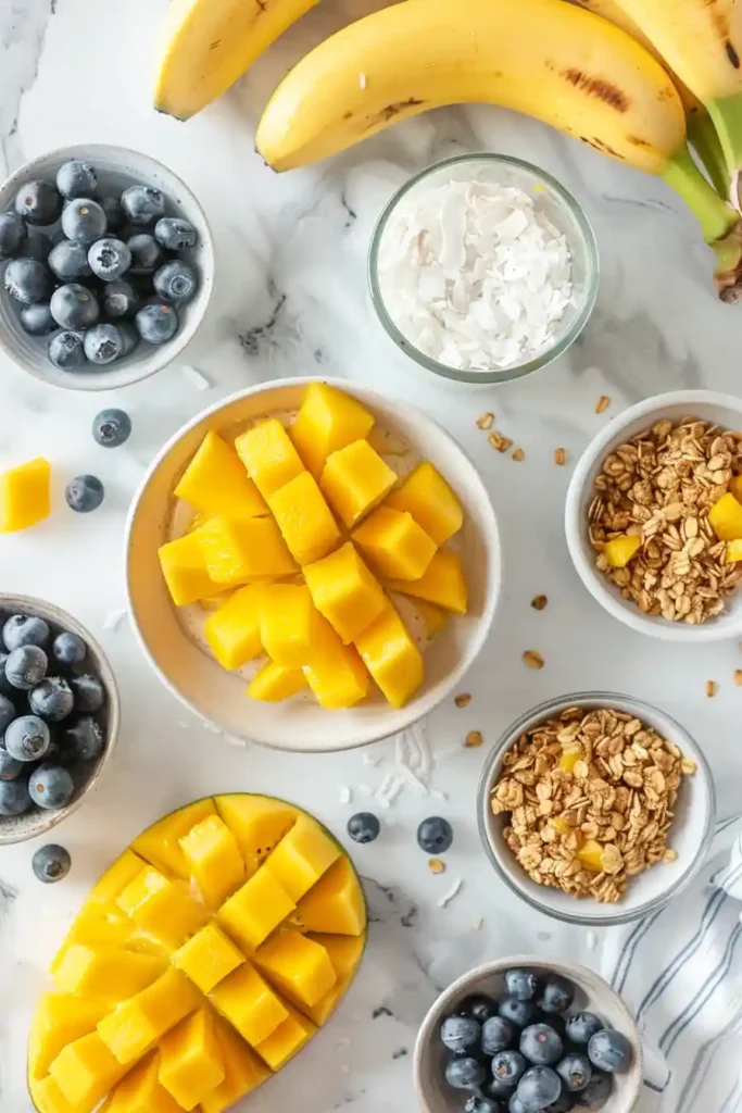 Healthy vegan smoothie bowl with mango base and crunchy granola topping.
