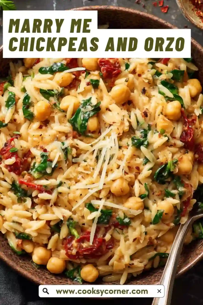 A bowl of Marry Me Chickpeas and Orzo with creamy sauce, spinach, and sun-dried tomatoes. The dish looks rich and comforting.