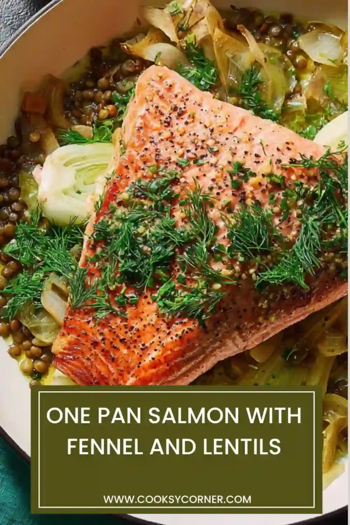 Baked salmon over lentils and fennel in a cast iron pan, garnished with herbs and lemon zest for a healthy dinner.