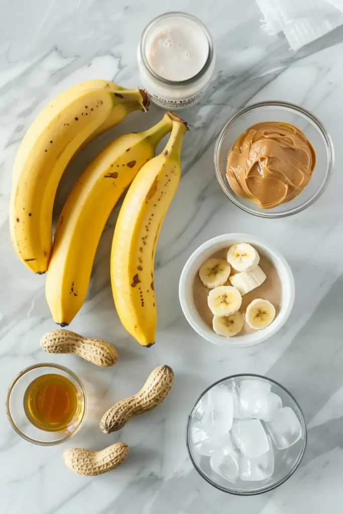 Close-up of creamy banana smoothie with peanut butter in a tall glass.