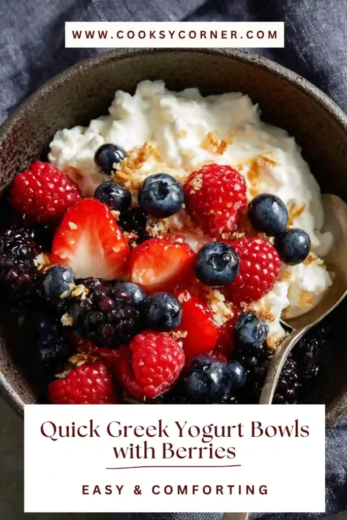 Healthy Greek yogurt bowl with blueberries, raspberries, and granola in a white bowl on a clean background.