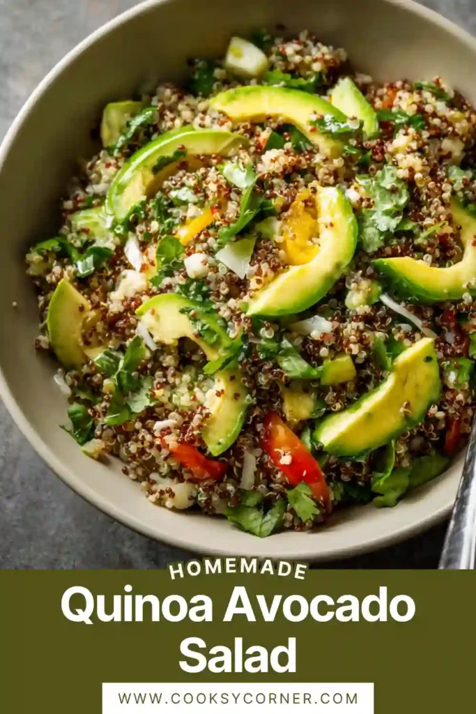 Fresh quinoa avocado salad with cherry tomatoes, cucumbers, and spinach in a large bowl with lemon dressing.