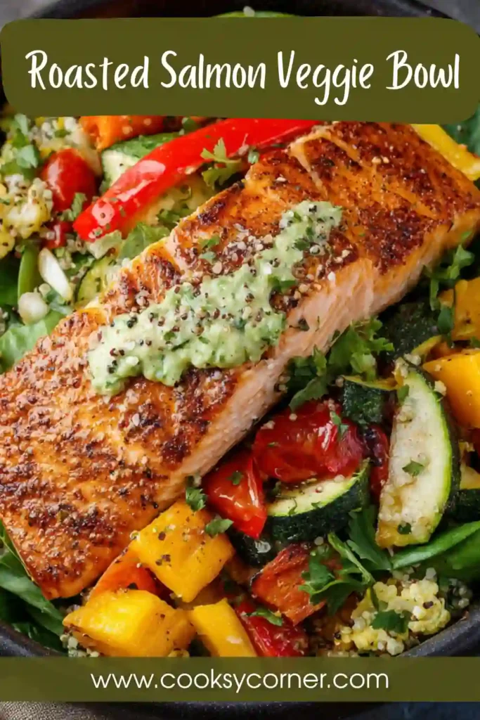 Roasted salmon veggie bowl with sweet potatoes, asparagus, and bell peppers served with fresh greens and pesto.