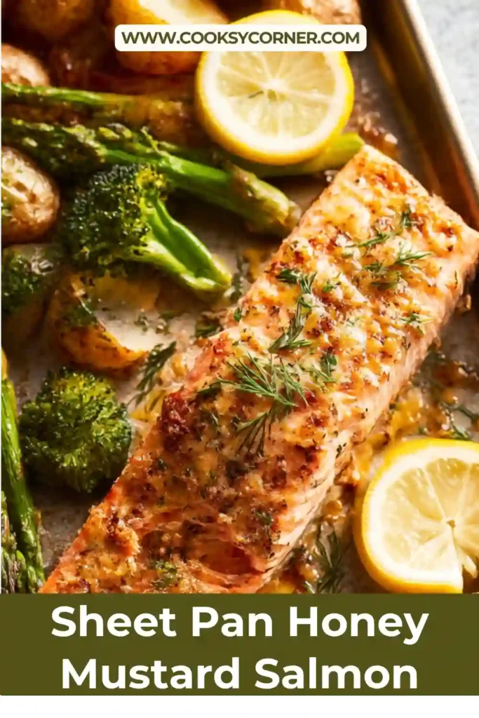 Sheet Pan Honey Mustard Salmon served with roasted broccoli and golden potatoes on a baking tray. The salmon looks flaky and glazed with a glossy sauce.