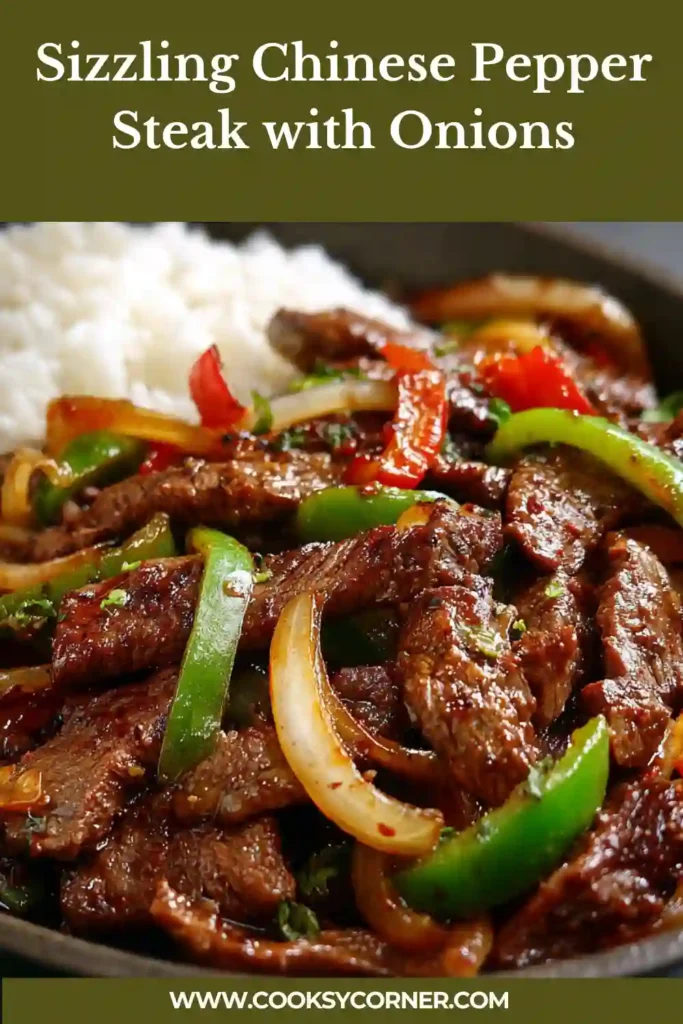 Sizzling Chinese pepper steak with onions served hot in a pan with glossy sauce and tender beef strips.