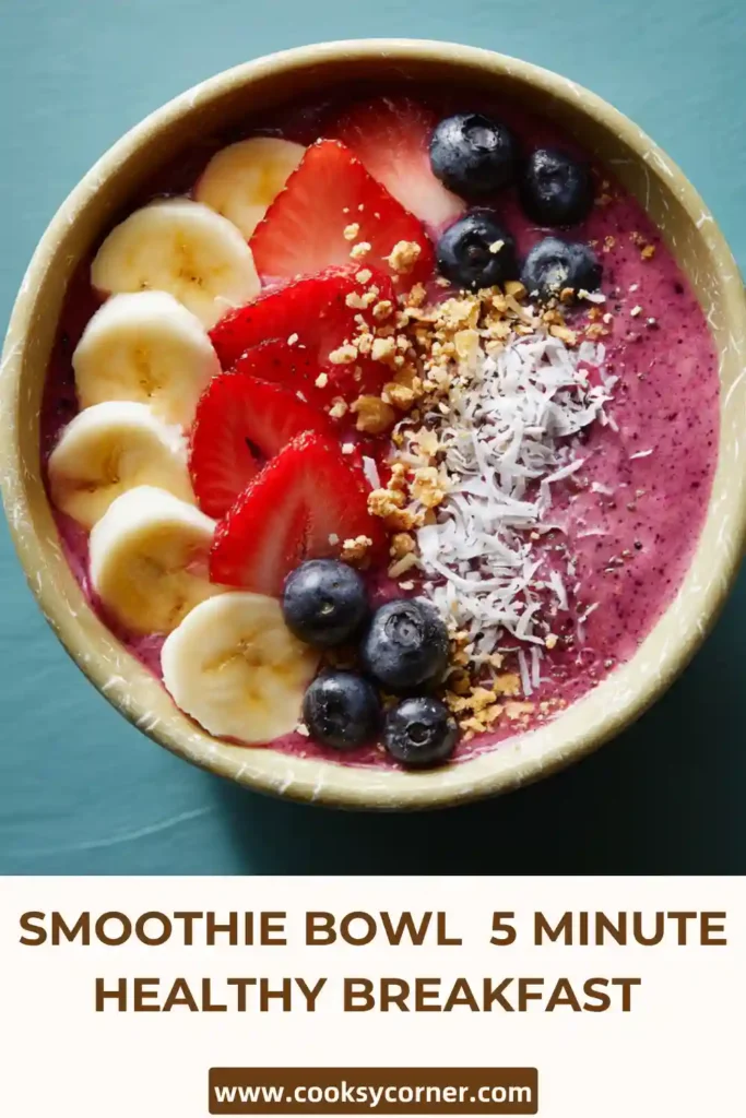 Vibrant smoothie bowl filled with mixed berries and topped with coconut, chia seeds, and fresh fruit slices.