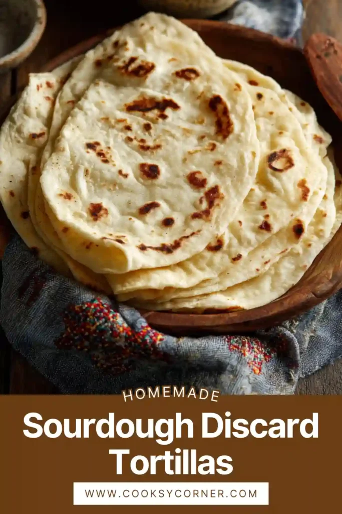 Sourdough discard tortillas stacked and freshly cooked in skillet.