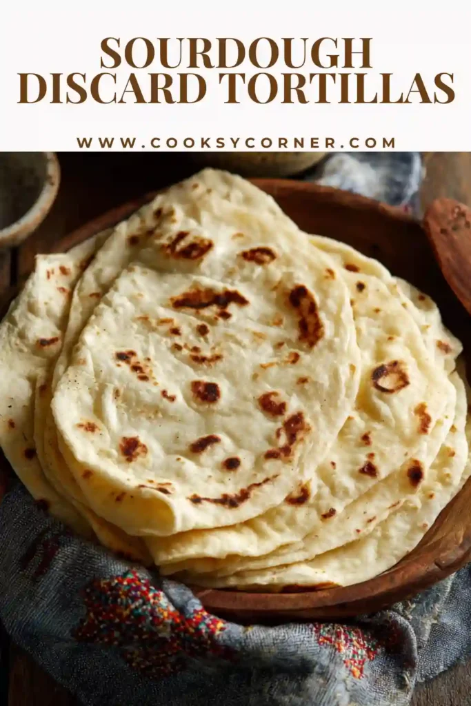 Sourdough discard tortillas stacked and freshly cooked in skillet.