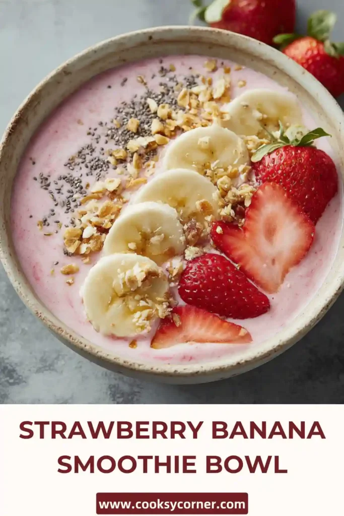 Strawberry banana smoothie bowl with vibrant pink color and fresh toppings arranged beautifully.