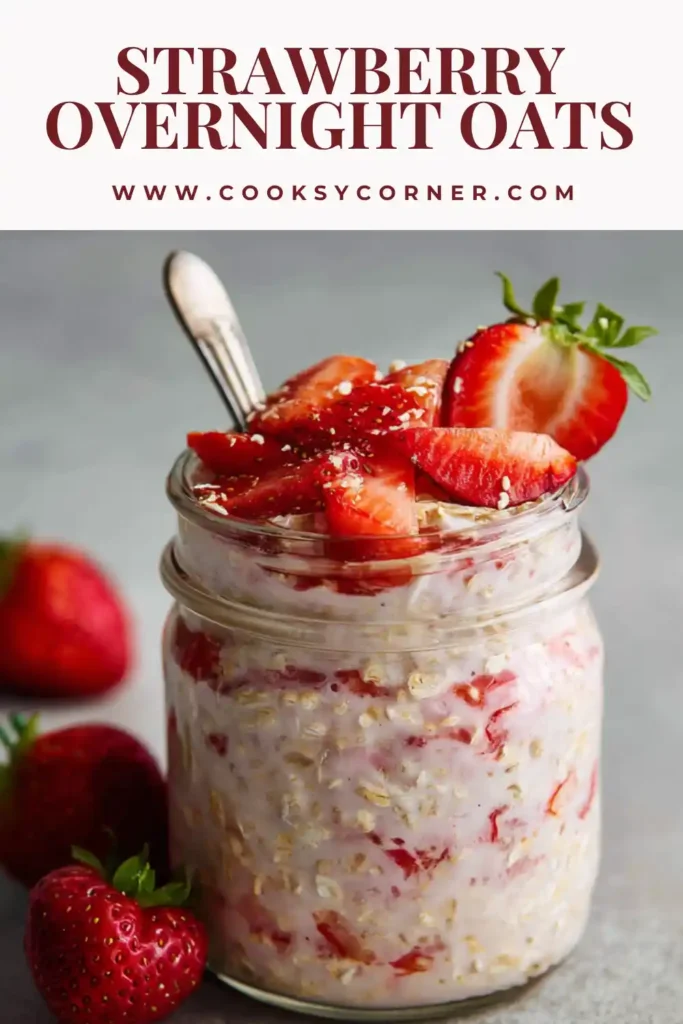 A jar of strawberry overnight oats topped with fresh strawberries and almonds, showing a creamy and thick texture perfect for a healthy breakfast.