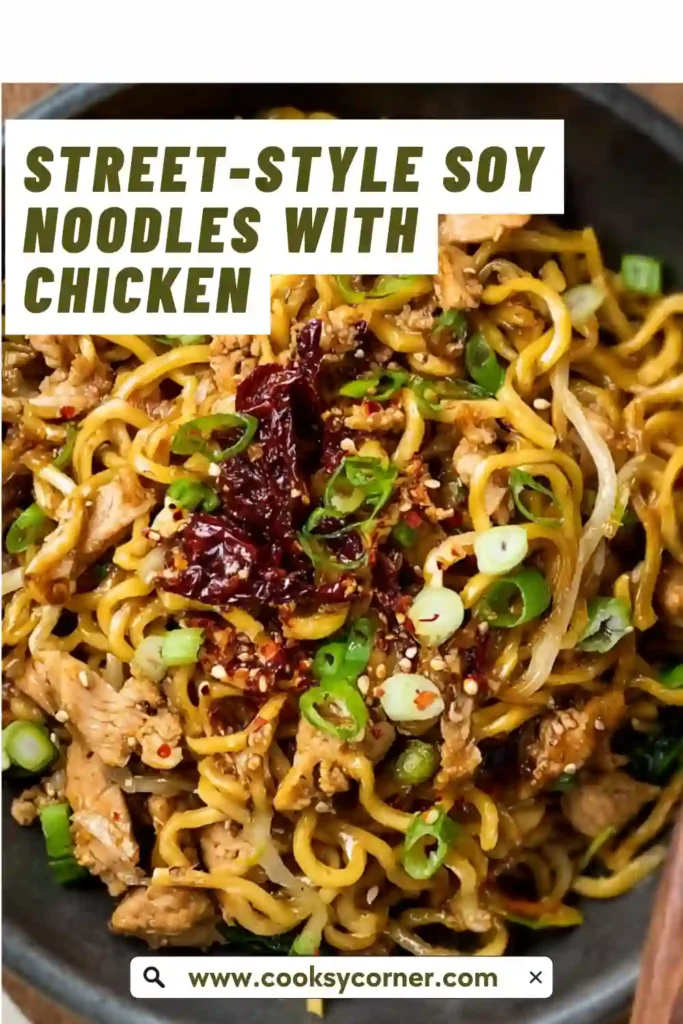 Close-up of chicken stir fry soy noodles with fresh vegetables and sesame garnish. The dish looks vibrant and freshly cooked.