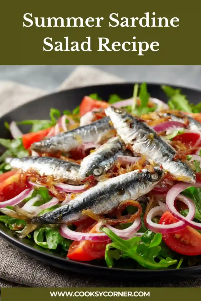 A fresh summer sardine salad served with leafy greens, cucumber, and lemon dressing on a white plate. The dish looks light, vibrant, and healthy.