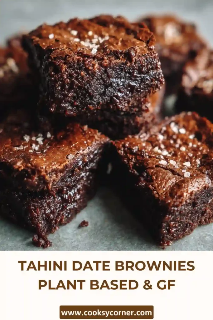 Fudgy tahini date brownies stacked on a plate with a rich chocolate texture and glossy top.