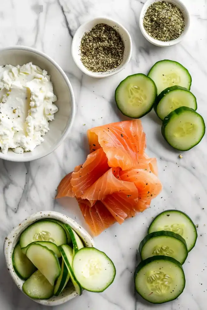Elegant salmon canapés served on cucumber slices with herbs.
