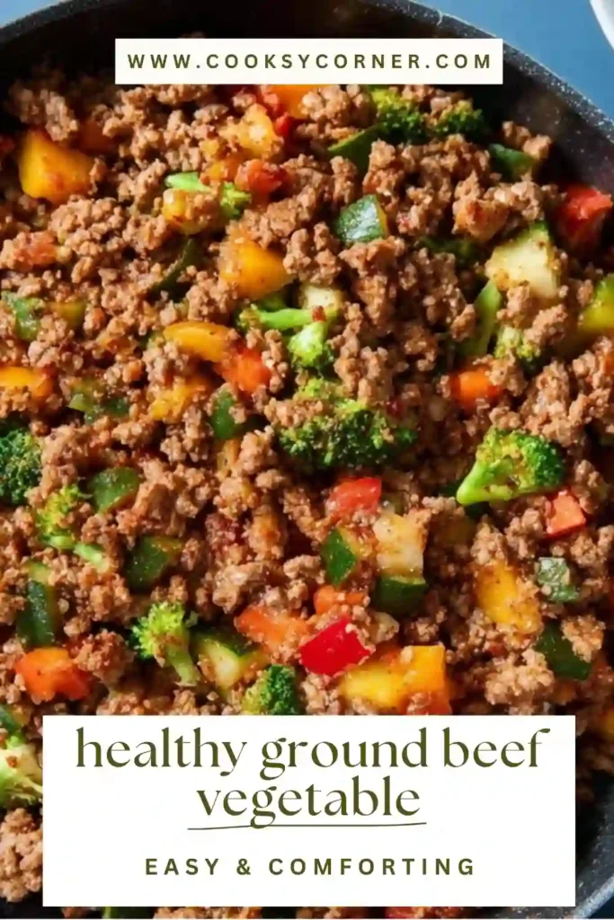 A skillet filled with seasoned ground beef, tomatoes, and mixed vegetables garnished with fresh cilantro. Bright and appetizing presentation.