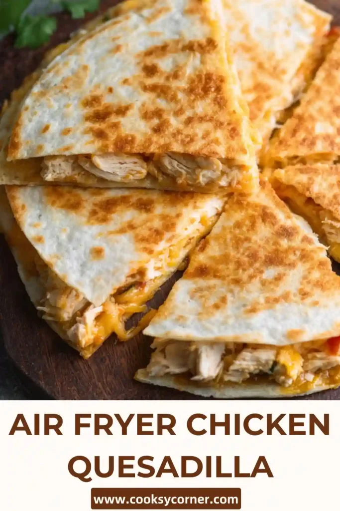 Crispy Air Fryer Chicken Quesadilla sliced and filled with melted cheese and shredded chicken on a plate. The golden tortilla looks crunchy and perfectly cooked.