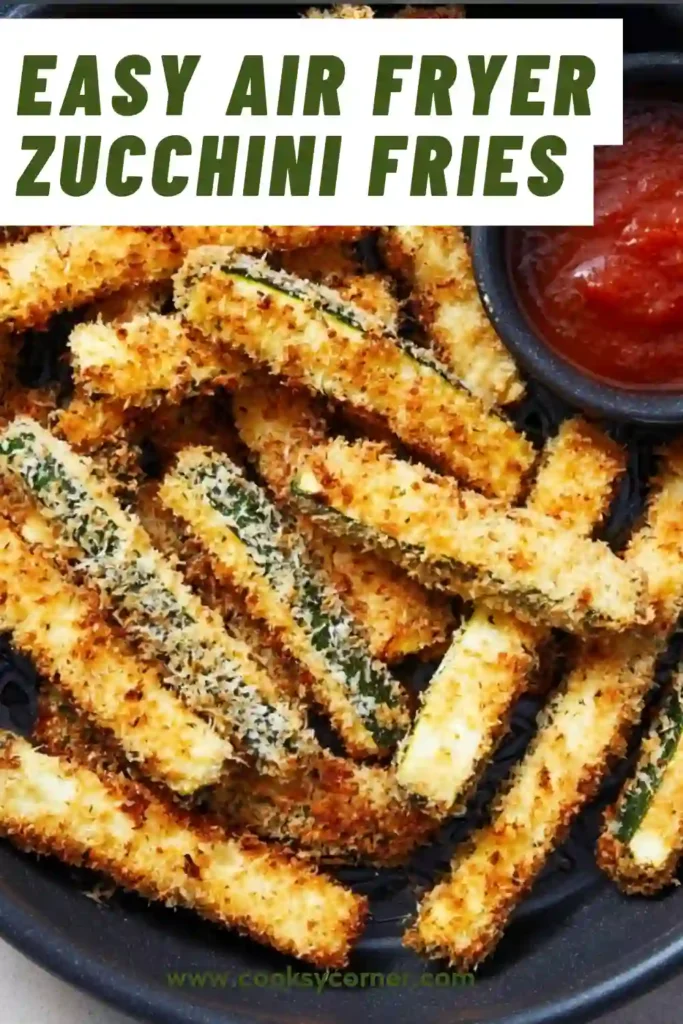 Freshly cooked air fryer zucchini fries arranged neatly with a side of marinara sauce.