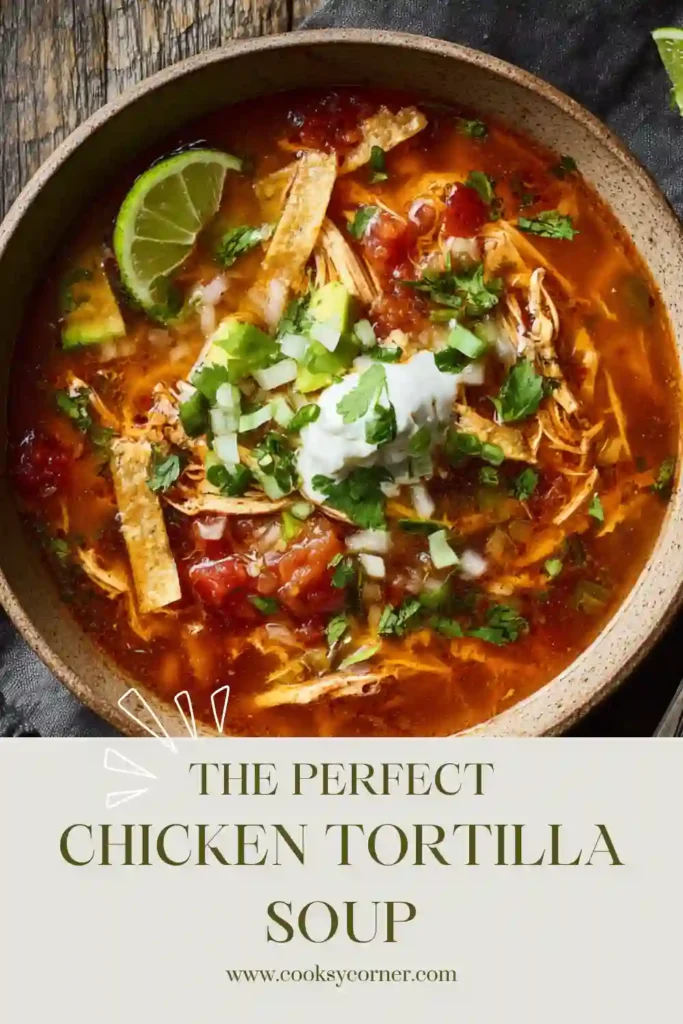 A bowl of homemade Tortilla Soup Recipe topped with crispy tortilla strips, avocado, shredded cheese, and fresh cilantro. This hearty chicken tortilla soup features a rich tomato broth with corn and poblano peppers.