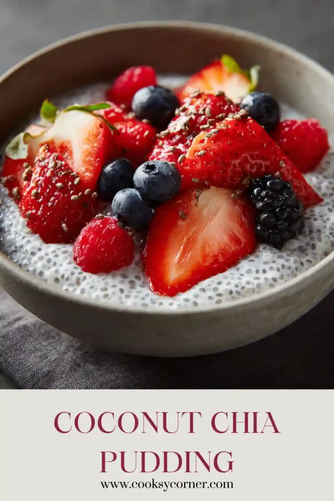 A glass jar filled with creamy Coconut Chia Pudding topped with fresh strawberries, blueberries, and blackberries. This vegan chia pudding recipe looks thick, healthy, and refreshing.
