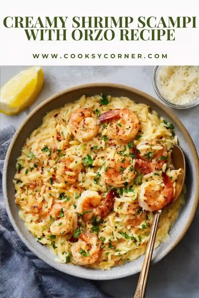 A skillet filled with Creamy Shrimp Scampi With Orzo featuring plump shrimp, creamy Parmesan sauce, tender orzo pasta, fresh parsley, and lemon wedges. This one-pan seafood dinner is rich, comforting, and packed with bright garlic and citrus flavors.
