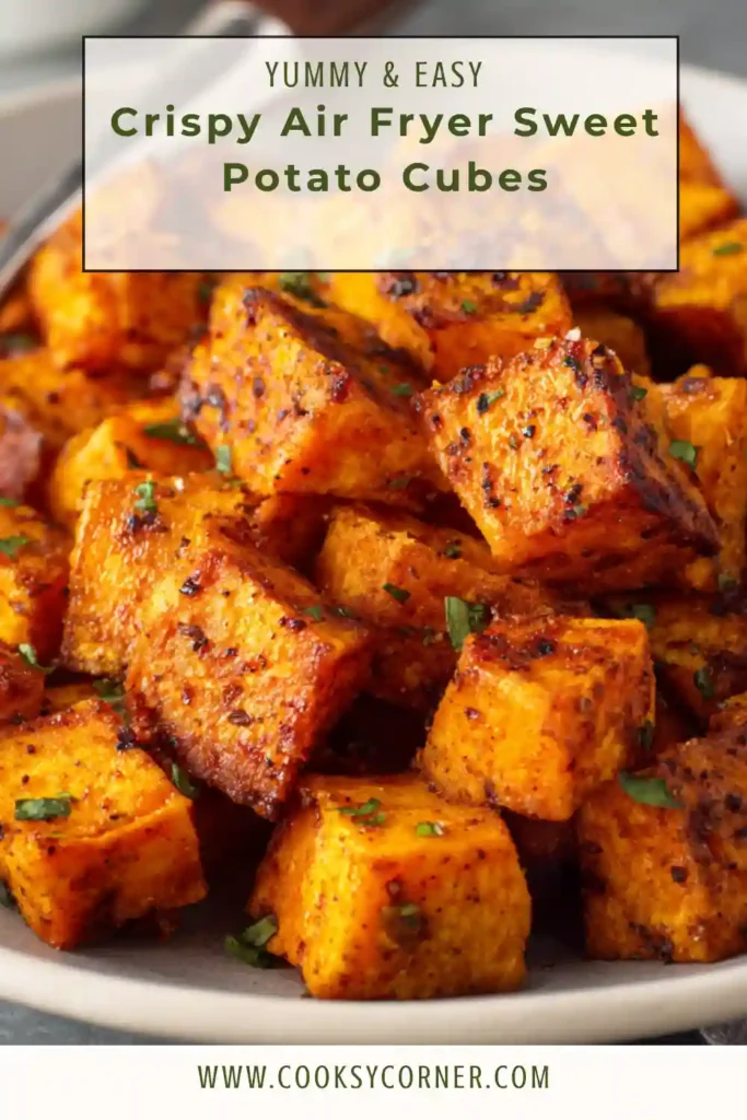 Golden Crispy Air Fryer Sweet Potato Cubes served warm in a bowl with fresh herbs. The sweet potatoes have crispy edges and rich savory seasoning.