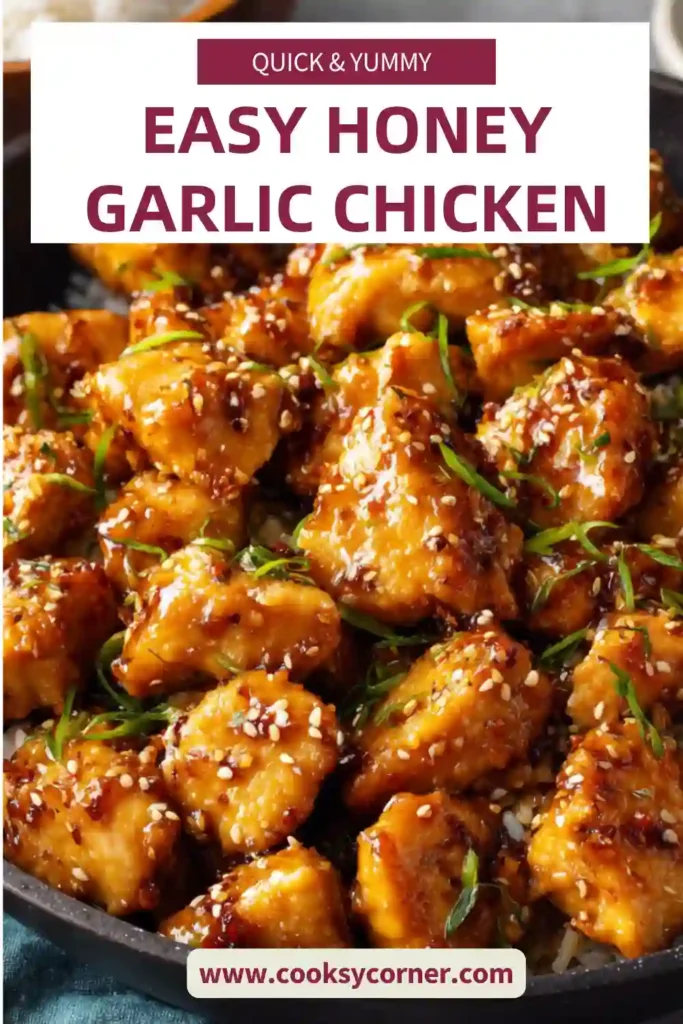 Close-up of sticky honey garlic chicken served over rice with fresh green onions and sesame seeds. The sauce appears thick and flavorful.
